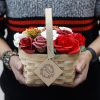 Großer roter Blumenstrauß in einem geflochtenen Korb